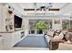 Living room featuring a large TV, comfortable sofa, and seamless indoor-outdoor flow to lanai at 5515 69Th E Pl, Ellenton, FL 34222