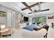 Living room with beams, a large TV, and a view of the backyard at 5515 69Th E Pl, Ellenton, FL 34222