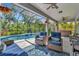 Relaxing outdoor space with comfortable seating, hot tub, screened pool, and lush landscaping offers a backyard oasis at 5515 69Th E Pl, Ellenton, FL 34222
