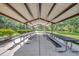 Community picnic shelter with long tables for gatherings, set in a grassy area with trees beyond at 5515 69Th E Pl, Ellenton, FL 34222