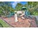 Community playground featuring climbing structures, slides, and swings, set in a wood chip safety surround at 5515 69Th E Pl, Ellenton, FL 34222