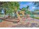 A large community playground with multiple slides, climbing structures, and swings, with green accents at 5515 69Th E Pl, Ellenton, FL 34222