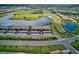 Aerial view showcases a beautiful condo community with convenient parking, surrounded by green spaces and scenic lakes at 5604 Palmer Cir # 103, Bradenton, FL 34211