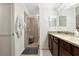 Bathroom with a tiled shower, a dark vanity with granite counters and tile floors at 5604 Palmer Cir # 103, Bradenton, FL 34211