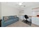 Comfortable room with a ceiling fan, a sofa, and a built-in desk with cabinets, perfect for relaxing or working at 5604 Palmer Cir # 103, Bradenton, FL 34211