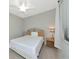 Cozy bedroom features a comfortable bed, a ceiling fan, and a nightstand with lamp for a tranquil retreat at 5604 Palmer Cir # 103, Bradenton, FL 34211