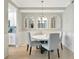 Bright dining area with round table, chairs, and three decorative windowpane mirrors at 5604 Palmer Cir # 103, Bradenton, FL 34211