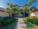 Stunning home featuring lush landscaping, a paver walkway, and a charming stone accent facade at 5604 Palmer Cir # 103, Bradenton, FL 34211