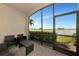 Enjoy outdoor living on the lanai, featuring comfortable seating and views of the lake and manicured landscape at 5604 Palmer Cir # 103, Bradenton, FL 34211