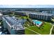 Aerial view of a condo community with a swimming pool, lake, and well-maintained grounds at 5750 Midnight Pass Rd # 203, Sarasota, FL 34242