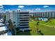Aerial view of condominium featuring lush landscaping, community pool, and stunning views at 5750 Midnight Pass Rd # 203, Sarasota, FL 34242