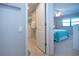 Open doorway to bathroom and bedroom with walk-in shower at 5750 Midnight Pass Rd # 203, Sarasota, FL 34242