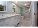 Bright bathroom with a double sink vanity and a glass-enclosed shower at 5750 Midnight Pass Rd # 203, Sarasota, FL 34242