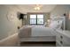Light-filled bedroom with a decorative white bed frame and large window with a view at 5750 Midnight Pass Rd # 203, Sarasota, FL 34242
