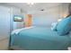 Bedroom featuring a bed with blue accents, tv, and a ceiling fan at 5750 Midnight Pass Rd # 203, Sarasota, FL 34242