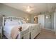 Bright bedroom with a decorative white bamboo bed frame and sliding barn door access to the bathroom at 5750 Midnight Pass Rd # 203, Sarasota, FL 34242