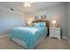 Nicely appointed bedroom with ceiling fan, beach-themed decor, and side tables at 5750 Midnight Pass Rd # 203, Sarasota, FL 34242