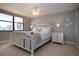 Cozy bedroom with elegant white furniture, a ceiling fan, and sunny window views, creating a relaxing atmosphere at 5750 Midnight Pass Rd # 203, Sarasota, FL 34242