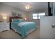 Nicely appointed bedroom with ceiling fan, beach-themed decor, and side tables at 5750 Midnight Pass Rd # 203, Sarasota, FL 34242