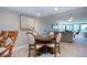 Dining table with seating for four adjacent to a living room with lots of natural light and bright paint at 5750 Midnight Pass Rd # 203, Sarasota, FL 34242
