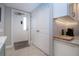 View of the condo entryway showing tile floors, a coat closet, and a convenient coffee station at 5750 Midnight Pass Rd # 203, Sarasota, FL 34242