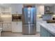 Modern kitchen features stainless steel appliances, white cabinets, and a tile backsplash at 5750 Midnight Pass Rd # 203, Sarasota, FL 34242