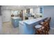 Modern kitchen offering stainless steel appliances, stylish white cabinets, light countertops, and a central island at 5750 Midnight Pass Rd # 203, Sarasota, FL 34242