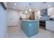 Modern kitchen with updated stainless steel appliances and a center island at 5750 Midnight Pass Rd # 203, Sarasota, FL 34242
