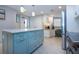 Spacious kitchen featuring an island with drawers, granite countertops, and an adjacent workspace with natural light at 5750 Midnight Pass Rd # 203, Sarasota, FL 34242