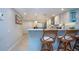 Kitchen with white cabinets, stainless appliances, island with bar seating, and plenty of countertop workspace at 5750 Midnight Pass Rd # 203, Sarasota, FL 34242