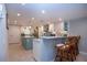 Modern kitchen with bar seating, island, white cabinets, granite counters, stainless steel appliances and easy access at 5750 Midnight Pass Rd # 203, Sarasota, FL 34242