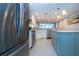 Galley kitchen featuring a center island, stainless appliances, and modern pendant lights at 5750 Midnight Pass Rd # 203, Sarasota, FL 34242