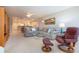 Relaxing living room with comfortable seating, glass coffee table and view to kitchen and dining spaces at 5750 Midnight Pass Rd # 203, Sarasota, FL 34242