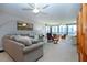 Bright living room with comfortable seating, floor-to-ceiling windows, and water views at 5750 Midnight Pass Rd # 203, Sarasota, FL 34242