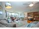 This bright living room boasts lots of natural light and cozy seating, complete with an adjacent view of the bedroom at 5750 Midnight Pass Rd # 203, Sarasota, FL 34242