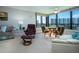Bright living room with comfortable seating, floor-to-ceiling windows with beautiful views at 5750 Midnight Pass Rd # 203, Sarasota, FL 34242