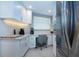 Bright kitchen nook with a dedicated office space with a granite counter, seating and lots of natural light at 5750 Midnight Pass Rd # 203, Sarasota, FL 34242