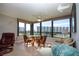 Sunroom with tile flooring and a wall of windows providing an abundance of natural light and beautiful views at 5750 Midnight Pass Rd # 203, Sarasota, FL 34242