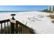 Beautiful beach with white sand and clear water featuring rows of beach chairs at 5880 Midnight Pass Rd # 202, Sarasota, FL 34242