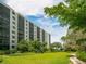 Modern condo building with lush landscaping, offering a serene and inviting environment at 5880 Midnight Pass Rd # 202, Sarasota, FL 34242