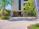 Inviting entrance to Casarina features tropical landscaping and a brick paved driveway at 5880 Midnight Pass Rd # 202, Sarasota, FL 34242