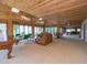Spacious living room with wood paneled walls and ceiling, with ample natural light and comfortable seating area at 5880 Midnight Pass Rd # 202, Sarasota, FL 34242