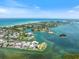 Beautiful aerial view showcasing the gorgeous turquoise waters and waterfront homes at 590 De Narvaez Dr, Longboat Key, FL 34228