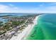 Expansive aerial view of coastal community with beautiful ocean and beachfront properties at 590 De Narvaez Dr, Longboat Key, FL 34228