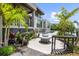 Lush backyard with fire pit and comfortable exterior seating next to the pool at 590 De Narvaez Dr, Longboat Key, FL 34228