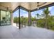 A home balcony offers scenic views with floor-to-ceiling glass windows and railing at 590 De Narvaez Dr, Longboat Key, FL 34228