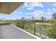 The balcony of this property offers great views of the water and tropical landscaping at 590 De Narvaez Dr, Longboat Key, FL 34228