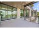 A home balcony offers panoramic views with floor-to-ceiling glass windows and railing at 590 De Narvaez Dr, Longboat Key, FL 34228