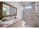 Bathroom features a glass shower, neutral finishes, and a framed mirror at 590 De Narvaez Dr, Longboat Key, FL 34228