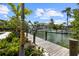 Beautiful waterfront view from the backyard dock with lush tropical landscaping at 590 De Narvaez Dr, Longboat Key, FL 34228